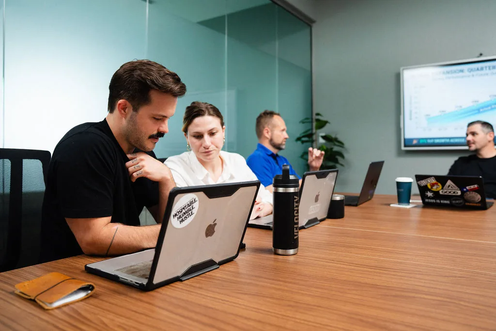 The conference room at Corridor Collective in San Marcos, in use for a working session with the wall display showing a chart